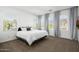Spacious main bedroom with a plush bed, large windows, and neutral decor for a cozy retreat at 4077 S Sabrina Dr # 14, Chandler, AZ 85248