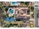 Stunning aerial view of a luxury home with a backyard pool, spa, and a private tennis court at 4547 S Banning Dr, Gilbert, AZ 85297