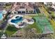 Beautiful backyard featuring a custom pool with rock features, hot tub, and a well-maintained sports court at 4547 S Banning Dr, Gilbert, AZ 85297