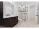 Modern bathroom featuring frameless shower, dual shower heads, and custom vanity at 4547 S Banning Dr, Gilbert, AZ 85297