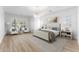 Bright bedroom with hardwood floors, chandelier, and a large window with shutters at 4547 S Banning Dr, Gilbert, AZ 85297