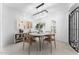 Bright dining room boasts modern chandelier, stylish decor, and an ornamental iron door at 4547 S Banning Dr, Gilbert, AZ 85297