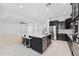 Bright kitchen features a large island with seating, stainless steel appliances, and dark cabinetry at 4547 S Banning Dr, Gilbert, AZ 85297