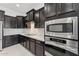 This kitchen includes stainless steel appliances, custom cabinetry, and stylish countertops at 4547 S Banning Dr, Gilbert, AZ 85297