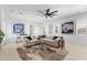 Spacious living room featuring neutral colors, a modern ceiling fan and lots of natural light at 4547 S Banning Dr, Gilbert, AZ 85297