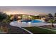 A backyard oasis featuring a luxurious pool with rock features, a spa, and a covered patio area perfect for relaxation at 4547 S Banning Dr, Gilbert, AZ 85297