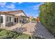 Backyard featuring a well-maintained lawn, landscaping, and covered patio at 515 W Smoke Tree Rd, Gilbert, AZ 85233