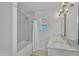 Bright bathroom with dual sinks, marble countertops, and tiled shower at 515 W Smoke Tree Rd, Gilbert, AZ 85233