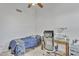 Cozy bedroom with carpeted floor, ceiling fan, workstation, and natural light at 515 W Smoke Tree Rd, Gilbert, AZ 85233