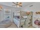 Cozy bedroom featuring a bunk bed, ceiling fan, and a playful, inviting atmosphere at 515 W Smoke Tree Rd, Gilbert, AZ 85233
