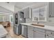 Modern kitchen with gray cabinetry, quartz countertops, stainless steel appliances and large stainless steel refrigerator at 515 W Smoke Tree Rd, Gilbert, AZ 85233