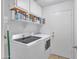 Clean laundry room with modern washer and dryer, shelving, and tile floor at 515 W Smoke Tree Rd, Gilbert, AZ 85233