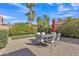 Backyard patio with brick pavers, outdoor furniture and palm trees at 515 W Smoke Tree Rd, Gilbert, AZ 85233