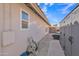 Narrow side yard with paved walkway for utility access along the side of the home at 515 W Smoke Tree Rd, Gilbert, AZ 85233