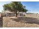 Expansive backyard with mature tree, block fence, and desert landscaping potential for creating an oasis at 5423 S Palm Dr, Tempe, AZ 85283