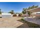Spacious backyard with covered patio, shed, and well-maintained landscaping at 5423 S Palm Dr, Tempe, AZ 85283