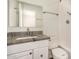 Bathroom with a gray countertop and a white tiled shower at 5423 S Palm Dr, Tempe, AZ 85283