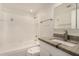 Clean white bathroom featuring tub and shower, sink, vanity and medicine cabinet at 5423 S Palm Dr, Tempe, AZ 85283