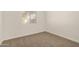 Bright bedroom featuring neutral carpet, white walls and window providing natural light at 5423 S Palm Dr, Tempe, AZ 85283