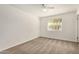Light-filled bedroom with neutral carpet and view of the outside at 5423 S Palm Dr, Tempe, AZ 85283