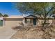 Charming single-story home with a well-maintained lawn, brick facade, and a two-car garage at 5423 S Palm Dr, Tempe, AZ 85283