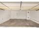 Spacious garage with concrete flooring, white walls, and an overhead garage door at 5423 S Palm Dr, Tempe, AZ 85283