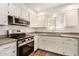 Bright kitchen featuring white cabinets, stainless steel appliances, and modern countertops at 5423 S Palm Dr, Tempe, AZ 85283