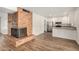 Cozy living room with a brick fireplace flowing into the kitchen at 5423 S Palm Dr, Tempe, AZ 85283
