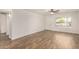 Bright living room with new flooring, a ceiling fan, and a view of the front yard at 5423 S Palm Dr, Tempe, AZ 85283