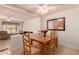 Bright dining area featuring wood table, chairs, and open view to living room at 5808 E Brown Rd # 119, Mesa, AZ 85205