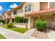 Charming condo featuring stucco exterior, tiled roof, well-maintained landscaping, and inviting walkway at 5808 E Brown Rd # 119, Mesa, AZ 85205