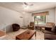 Cozy living room with tile floors, ceiling fan, and large window for natural light at 5808 E Brown Rd # 119, Mesa, AZ 85205