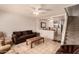Inviting living room with tile flooring, ceiling fan, and stairs leading to the upper level at 5808 E Brown Rd # 119, Mesa, AZ 85205