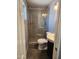 Bathroom features a glass enclosed shower with gray tiling and wood-look flooring at 5916 W Coronado Rd, Phoenix, AZ 85035