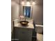 Half-bathroom features decorative sink and toilet at 5916 W Coronado Rd, Phoenix, AZ 85035