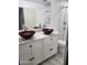 Bathroom with double vanity featuring modern vessel sinks and decorative tiling at 5916 W Coronado Rd, Phoenix, AZ 85035