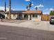 Charming single-story home with a well-maintained yard, solar panels, and mature palm trees at 5916 W Coronado Rd, Phoenix, AZ 85035