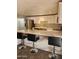 Bright kitchen features white cabinets, stainless appliances, and center island with bar seating at 5916 W Coronado Rd, Phoenix, AZ 85035