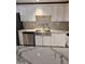 Bright kitchen features white cabinets, stainless appliances, and stylish countertop at 5916 W Coronado Rd, Phoenix, AZ 85035