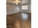 Spacious living room boasts beautiful wood-look flooring and a ceiling fan at 5916 W Coronado Rd, Phoenix, AZ 85035