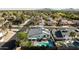 An aerial view of a home with a pristine pool and green spaces in a quiet residential neighborhood setting at 6174 E Janice Way, Scottsdale, AZ 85254