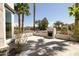 Backyard patio featuring a fireplace, low garden wall, and desert landscaping at 6174 E Janice Way, Scottsdale, AZ 85254