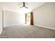 Spacious carpeted bedroom with natural light, featuring a modern ceiling fan and neutral colors at 6174 E Janice Way, Scottsdale, AZ 85254