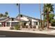 A view of the exterior of the home showing the desert landscaping, curb, and architectural details at 6174 E Janice Way, Scottsdale, AZ 85254
