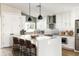Modern kitchen with a large island, stainless steel appliances, white cabinets, and stylish pendant lighting at 6174 E Janice Way, Scottsdale, AZ 85254