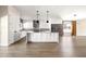 Modern kitchen with white cabinets, stainless steel appliances, gray backsplash and spacious island at 6174 E Janice Way, Scottsdale, AZ 85254