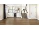 Bright living room with bar area, mini-fridge, modern staircase, hardwood floors and a neutral palette at 6174 E Janice Way, Scottsdale, AZ 85254