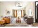 Inviting living room featuring a ceiling fan, large windows with curtains, and comfortable seating arrangement at 6174 E Janice Way, Scottsdale, AZ 85254