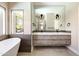 Bright main bathroom features double sink vanity, modern fixtures, and a luxurious freestanding tub at 6174 E Janice Way, Scottsdale, AZ 85254