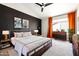 Modern main bedroom showcasing a black accent wall, a ceiling fan, and neutral color decor at 6174 E Janice Way, Scottsdale, AZ 85254